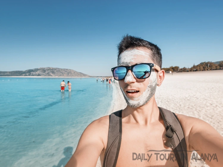 Man with white mud on his face in Salda lake