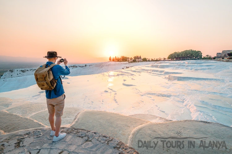 Tourist taking pictures in Pamukkale at sunset