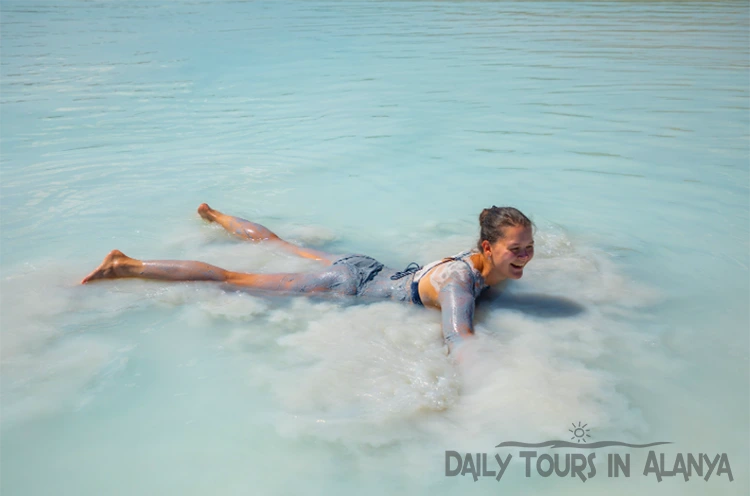 Woman swimming in muddy water in Salda Lake